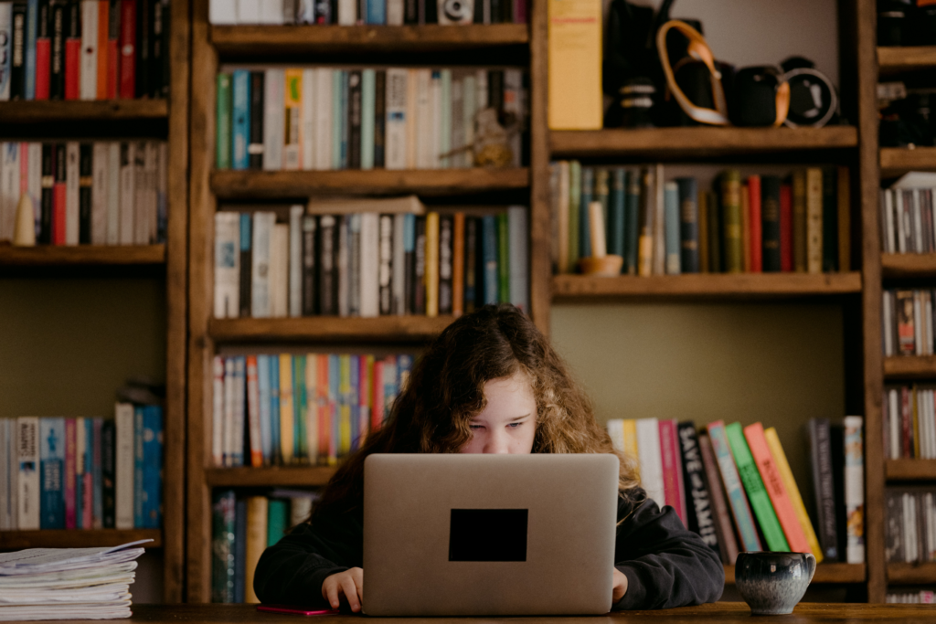 young girl looking at a laptop