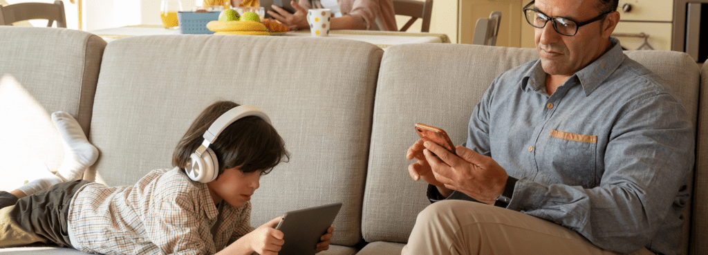 father and son on devices