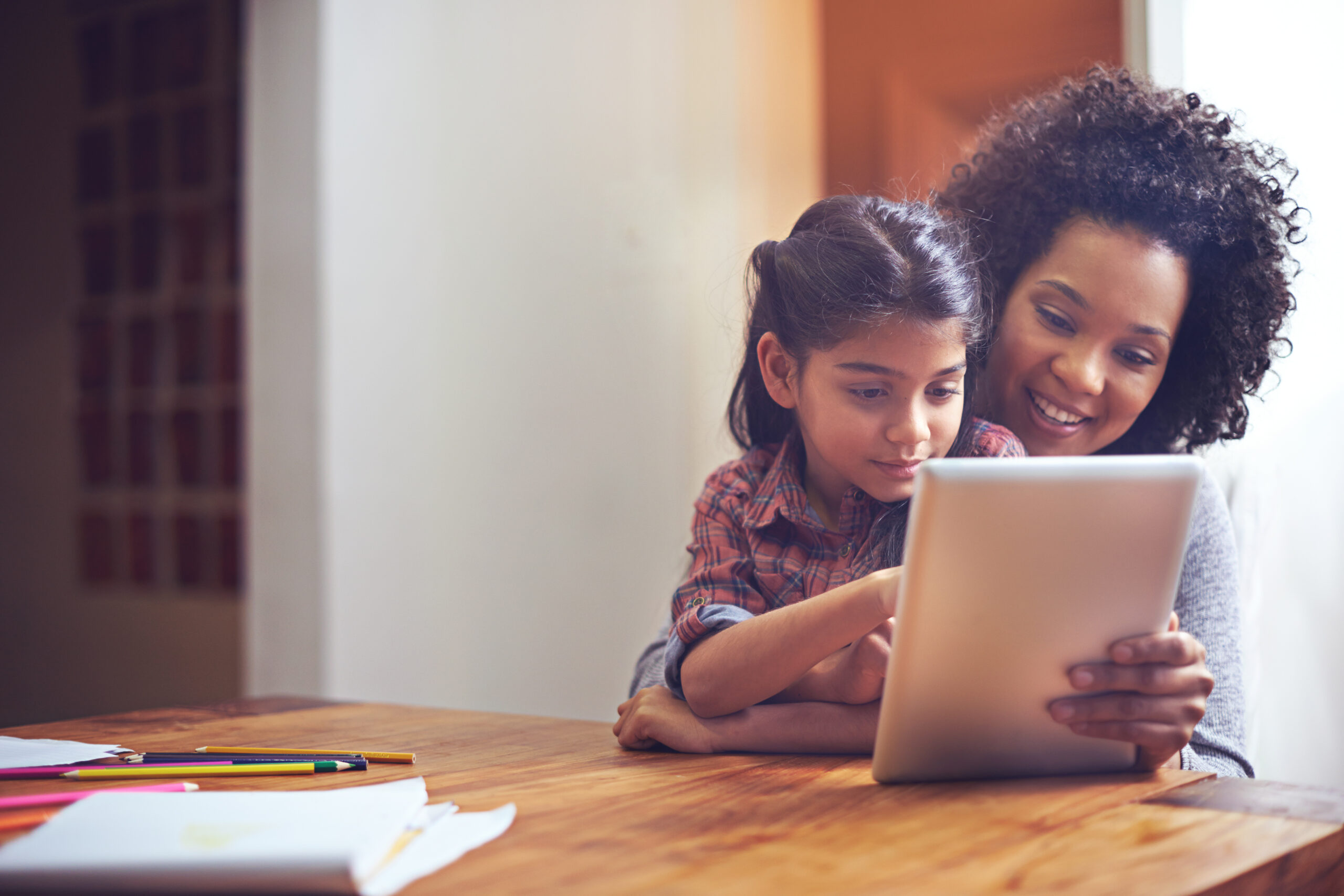 mother and daughter on an iPad